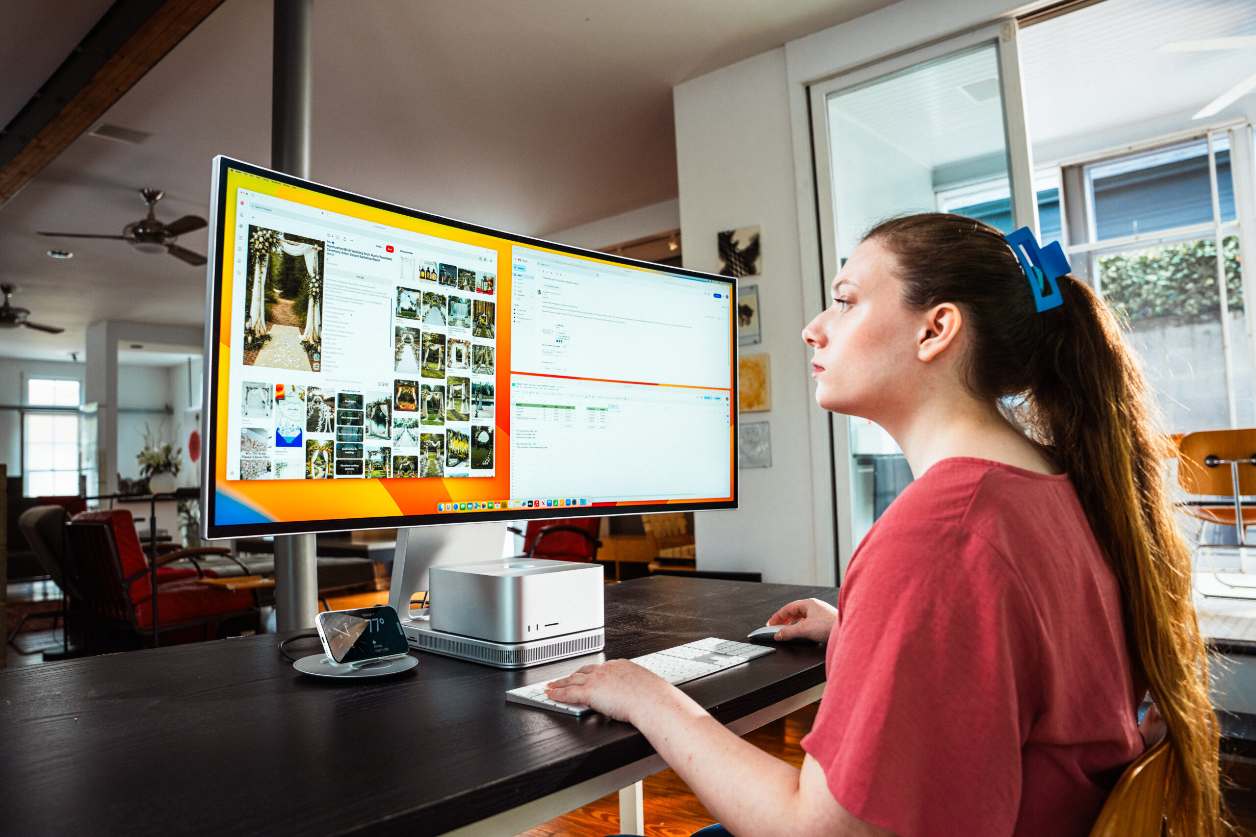 Prisma display with a Mac Studio, wireless charging stand, and keyboard on a clean desk